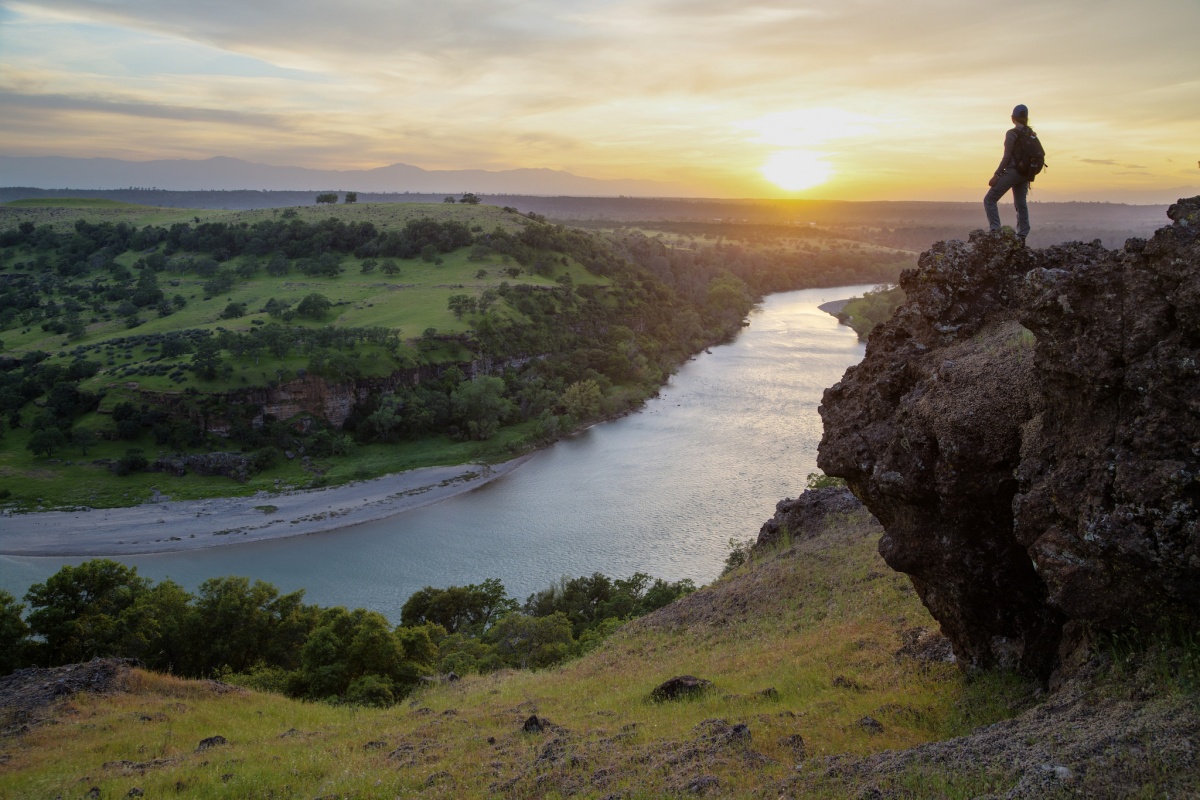 A women looks over the Sacramento River Bend Outstanding Natural Area in California at sunset, photo by Bob Wick, BLM