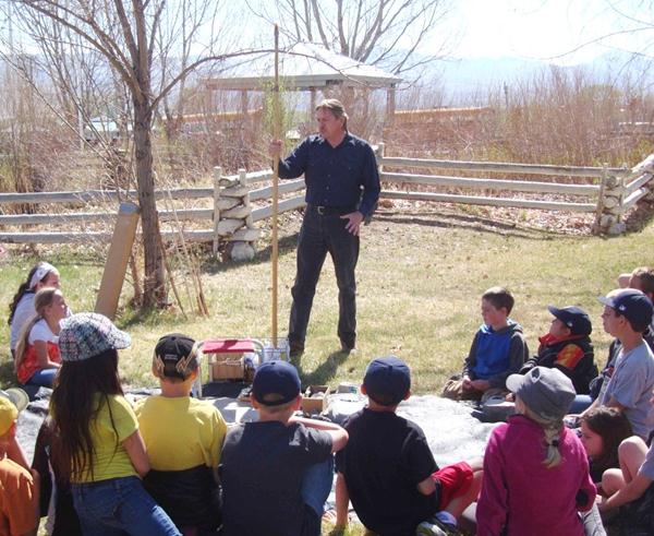 Wright holding a staff as part of his outdoor demonstration.