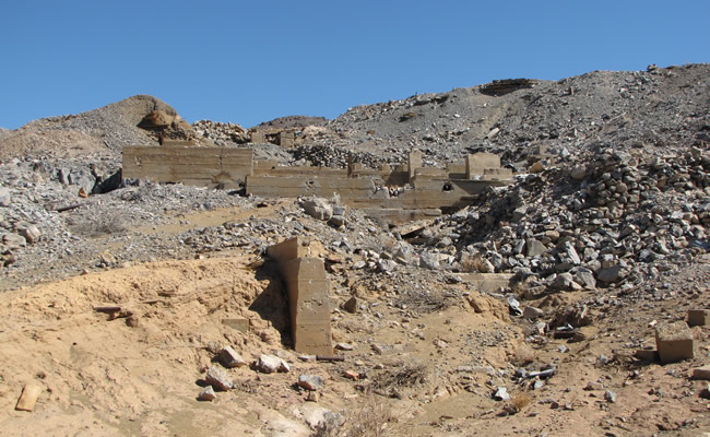 An abandoned mine structure sits on a rocky hillside. Photo by Peter Graves/BLM.