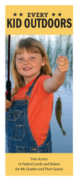 A child wearing denim overalls and an orange shirt holds up a small fish on a fishing line beside a calm body of water, with the “Every Kid Outdoors” banner above and program information below.