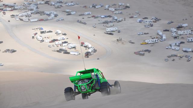 Dune buggy driving across sand dunes