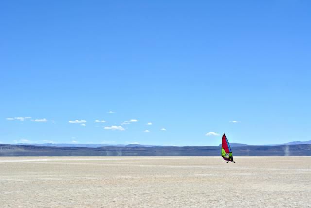 Kite boarder moves across the open landscape