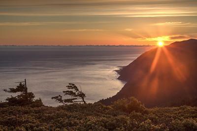 Sunset over mountains and the ocean.