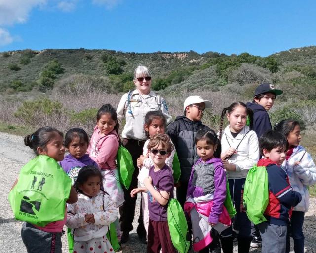 Students return from the Saturday hike and receive Junior Ranger supplies (backpacks, water bottles and bandannas)&nbsp; provided by Fort Friends.&nbsp;