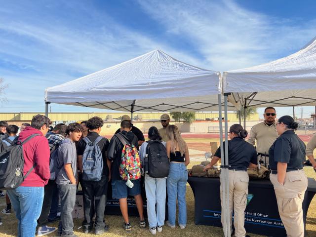 BLM staff speak with students at booth from left, Park Ranger Lead Michael Mujica in a black shirt, Park Ranger Damian Montano and Law Enforcement Ranger Alfonso Luquin. Photo by Arturo Casarez BLM.&nbsp;