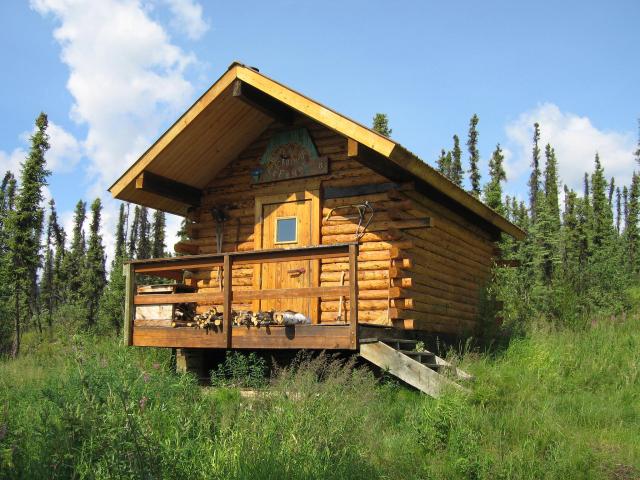Log cabin with woods in the background