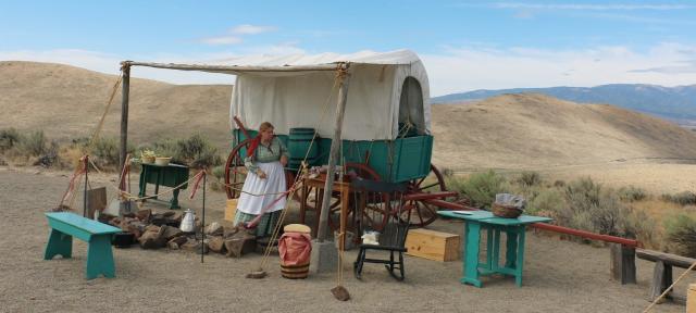 Oregon Trail wagon encampment with re-enactors showing the pioneer experience