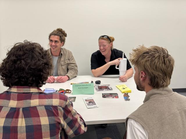 BLM Utah geologist speaking with youth around a table.
