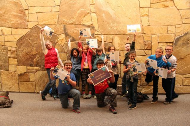 Fourth-grade students display their Every Kid in a Park passes at the NHTIC
