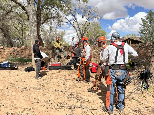 A group of people gather around materials