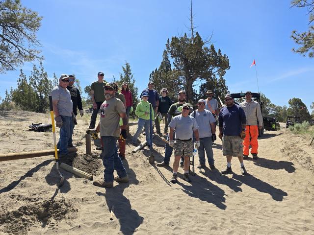 group of volunteers repairing fencing
