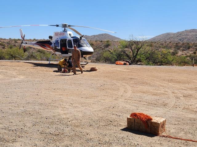 a helicopter at a gravel landing zone