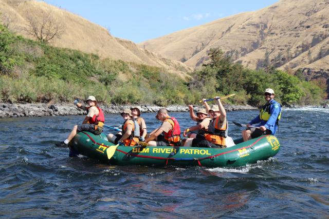 A group of youth in a raft on the river
