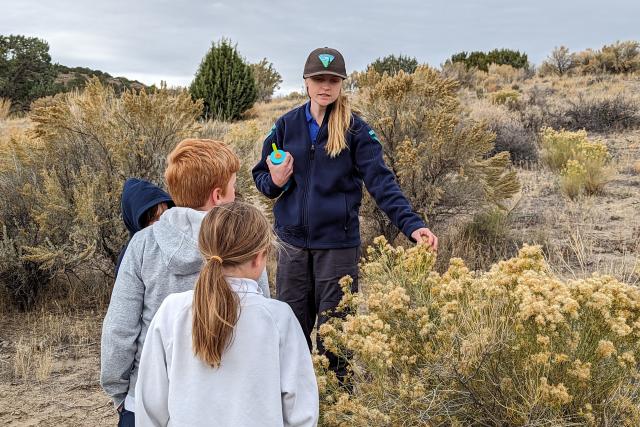 Ranger pointing to sagebrush during education program for children