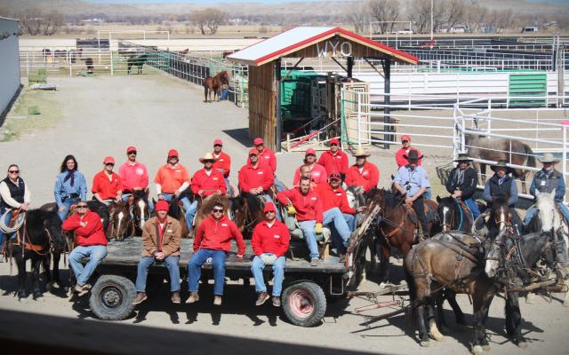 Wyoming Honor Farm team poses for photo with the backdrop being the farm