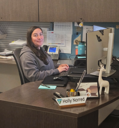 Support tech sits at her desk.