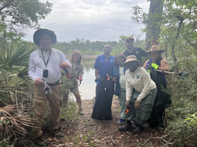  A successful cleanup day ends with collected debris and a healthier habitat for local wildlife. (From left to right: Planning and Environmental Specialist, Joe Edmonds; Deputy District Manager Shayne Banks; Realty Specialist William Harris; Assistant District Manager, Support Services, Victoria Craft; Project Manager, Brandon Schurch; Geologist, Samirra Felix; and Administrative Support Assistant, Angela Dennis.)