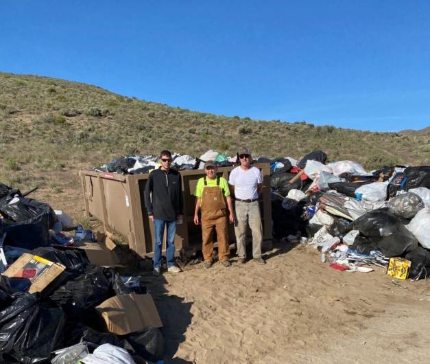 Cleanup volunteers pose for a photo with the trash they collected.