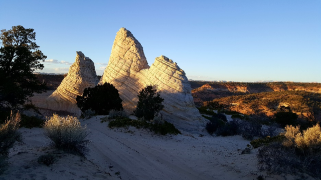 White, triangular, sandstone buttes along a dirt road