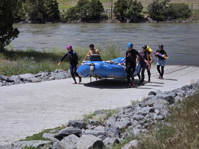 People are carrying a blue raft up the new boat launch at the Carbella Recreation site. 