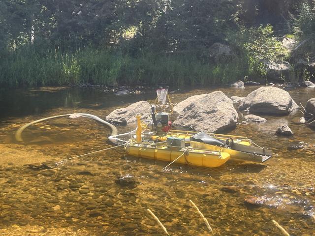 A suction dredge anchored in the creek as part of authorized in-stream activity, in Idaho.