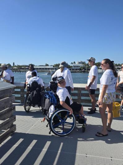 Cleanup participants pause along the pedestrian pier, enjoying panoramic views of the Jupiter Inlet and Loxahatchee River.