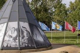 Modern teepee surrounded by flags
