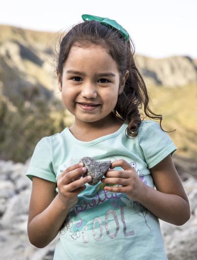 Girl holding heart-shaped rock