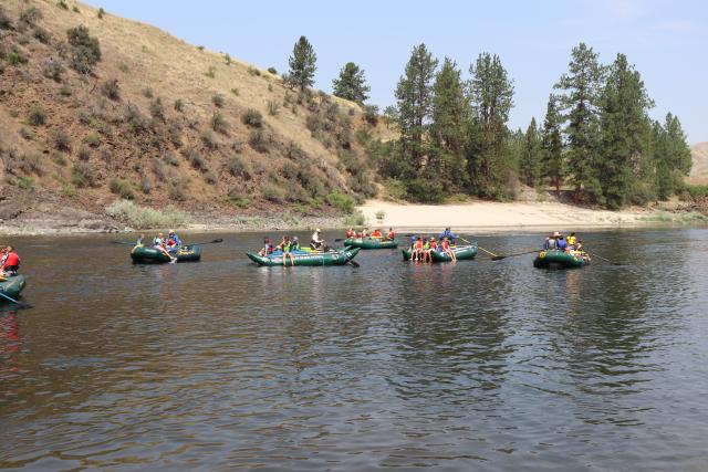 Students in rafts on the river