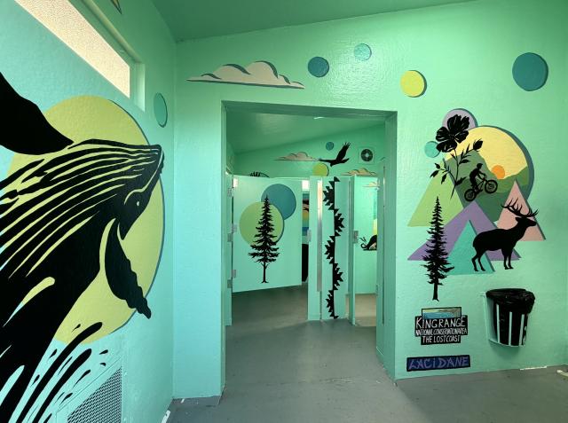 A green interior with paintings of sea creatures on the wall