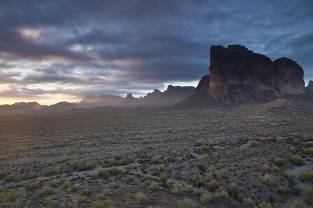 Sun peaks through clouds above the Eagletail Mountains Wilderness in Arizona.