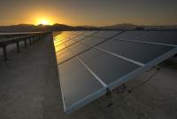 Sun sets over a row of solar panels
