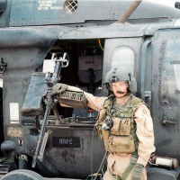 Soldier in front of helicopter gunner seat