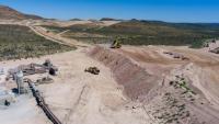 A aerial shot of an open pit mine in the desert.
