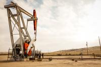 An Oil Derrick in dry hills.