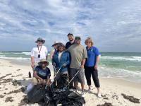 SSDO staff (from left to right: Planning and Environmental Specialist, Joe Edmonds; Geologist, Samirra Felix; Administrative Support Assistant, Angela Dennis; Assistant District Manager, Support Services, Victoria Craft; Project Manager, Brandon Schurch; Realty Specialist William Harris; and Deputy District Manager Shayne Banks) team up on the shoreline of Fort Morgan, AL to collect debris and protect coastal habitats.