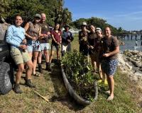 Group of people standing together outside with plants