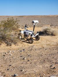 Rover navigating the Plaster City Open Area with a blue sky