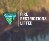Text saying FIRE RESTRICTIONS LIFTED GRAPHIC with blurry background