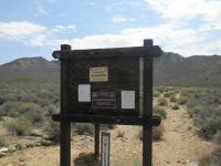 a wooden kiosk in a desert environment