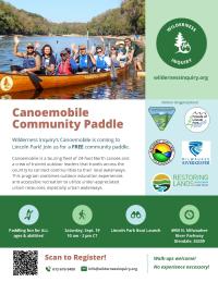 A group of people wearing life jackets sit together in a large wooden canoe on a calm river, smiling and waving at the camera. The canoe has “Wilderness Inquiry” written on the side. Behind them, trees line both sides of the river under a bright blue sky. The right side of the image shows a green circular logo with a tree and people, labeled “Wilderness Inquiry.” The flyer text below advertises a free community paddle event, including date, time, location, and partner organization logos.
