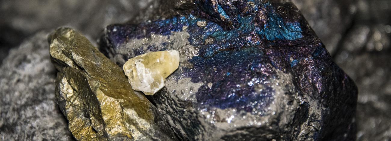 Shiny chalcopyrite, calcite crystal, and bornite