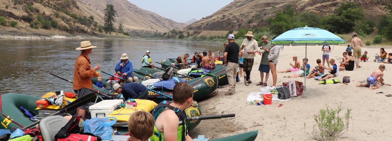 Image of students in rafts along rivershore