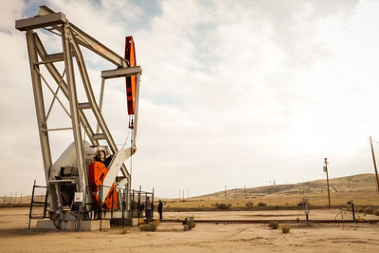 An Oil Derrick in dry hills.