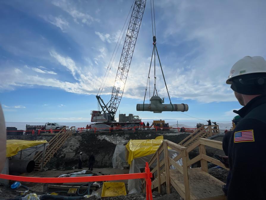 Agency individuals oversee pipeline work. 