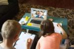 two children with computer doing distance learning from the Campbell Creek Science Center