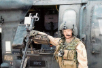 Soldier in front of helicopter gunner seat