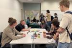 A group of youth talking to BLM Utah geologists around a table.