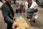 Curator of Paleontology John Scanella, Paleontology Lab and Field Manager Lee Hall, and Senior Director of Exhibitions and Planetarium Scott Williams discuss tooth gouges on an Edmontosaurus skull on display at the Museum of the Rockies Hall of Horns and Teeth. The gentlemen were on hand to crack open the display case for some close up photography on a recent visit by the DOI/BLM.