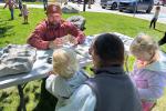 Kids handle fossils at a story time event in Pinedale WY with BLM staff member